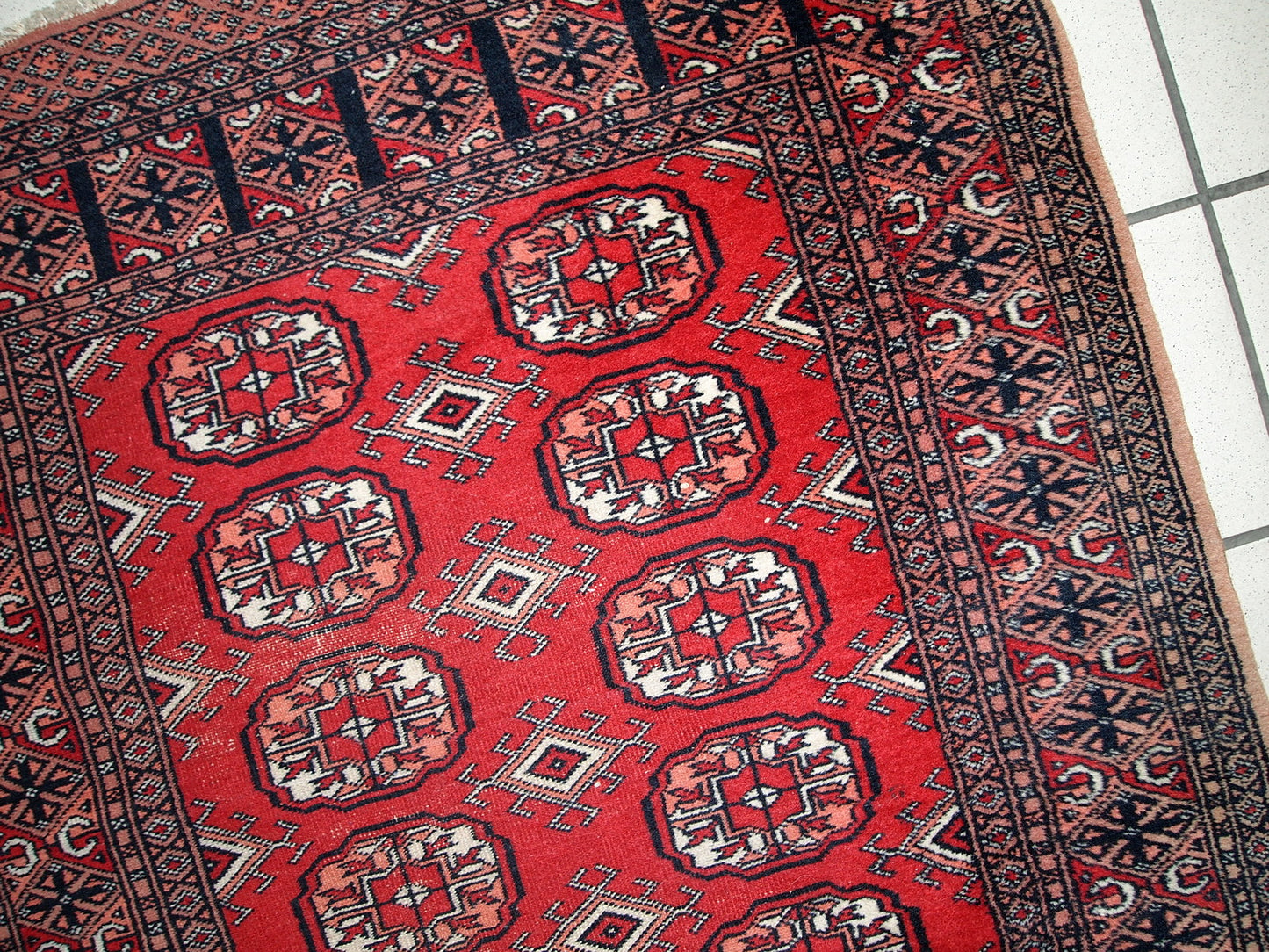 Handmade vintage Uzbek Bukhara runner in original condition, it has some age wear. The rug made in soft wool in the middle of 20th century.
