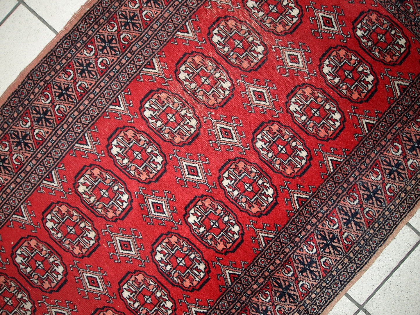 Handmade vintage Uzbek Bukhara runner in original condition, it has some age wear. The rug made in soft wool in the middle of 20th century.