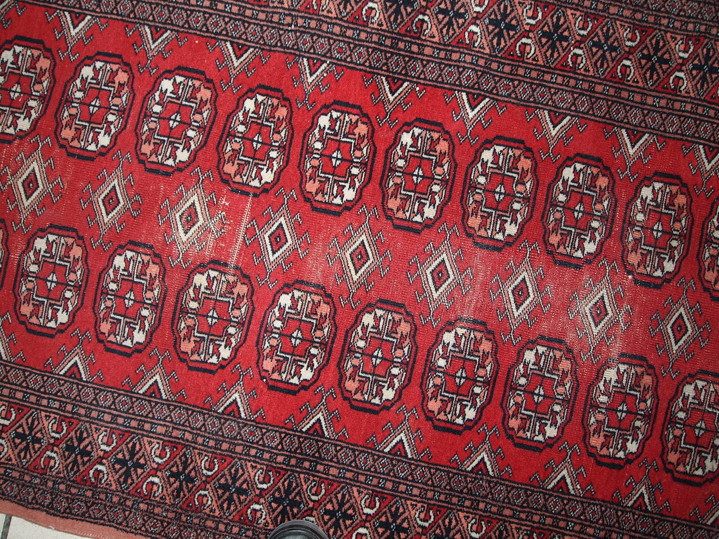 Handmade vintage Uzbek Bukhara runner in original condition, it has some age wear. The rug made in soft wool in the middle of 20th century.