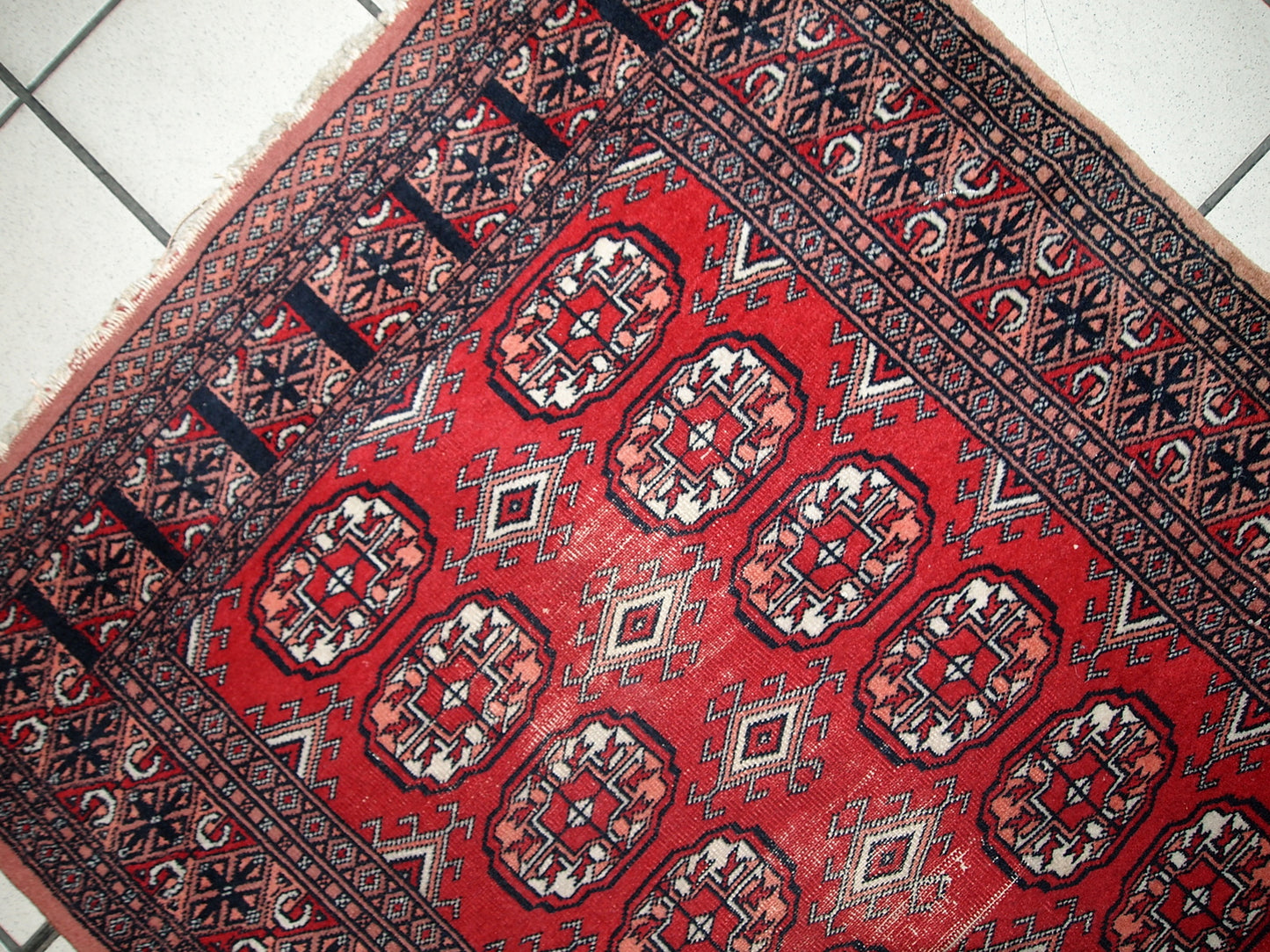 Handmade vintage Uzbek Bukhara runner in original condition, it has some age wear. The rug made in soft wool in the middle of 20th century.