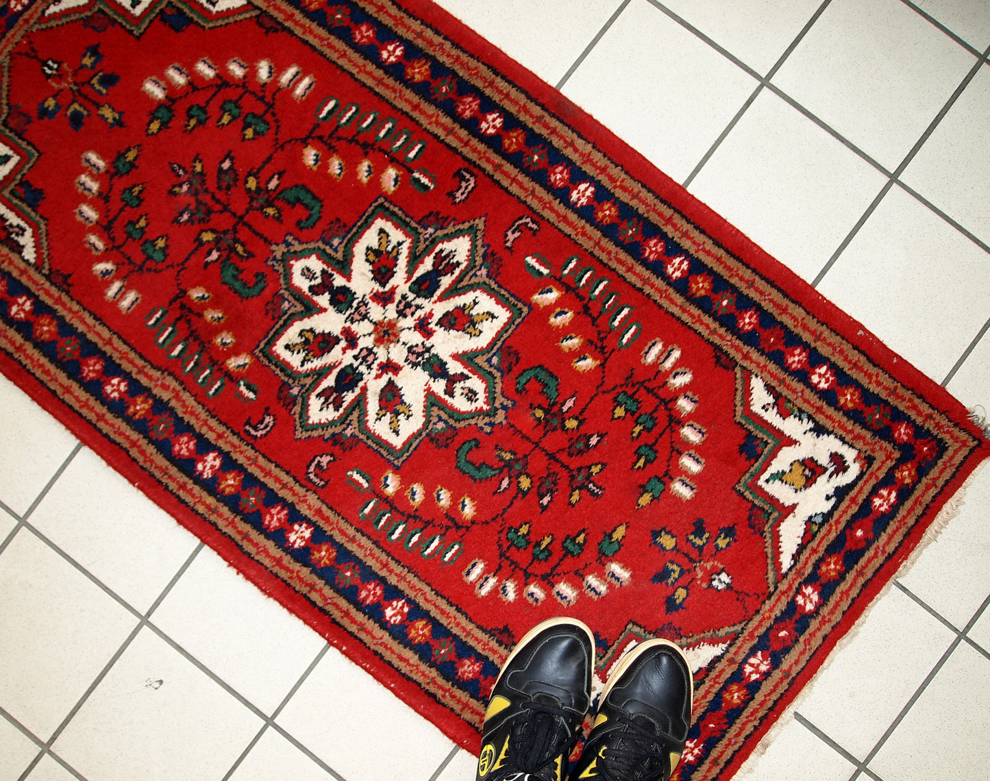 Handmade vintage Middle Eastern rug in traditional floral design. The rug is from the end of 20th century in original good condition.