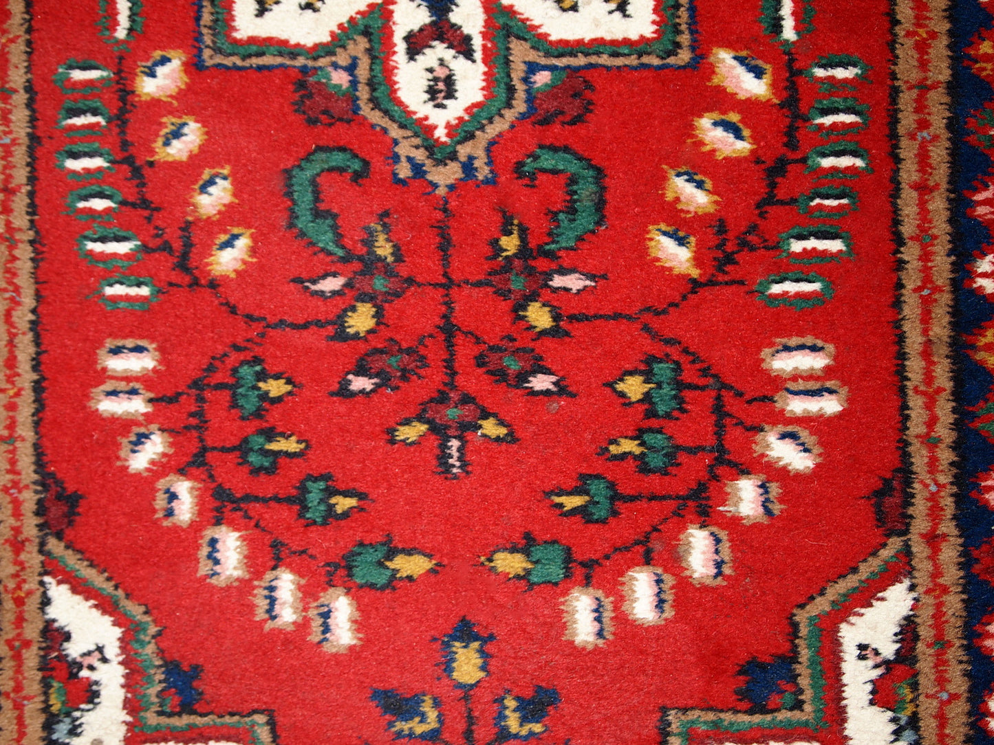 Handmade vintage Middle Eastern rug in traditional floral design. The rug is from the end of 20th century in original good condition.