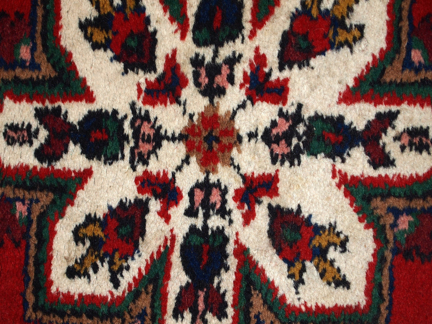 Handmade vintage Middle Eastern rug in traditional floral design. The rug is from the end of 20th century in original good condition.