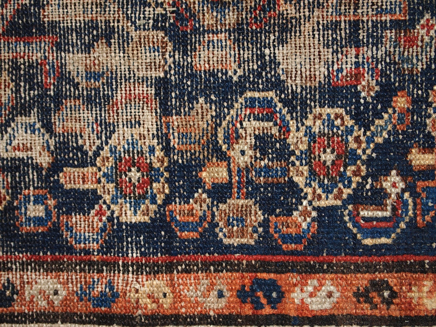 Handmade antique Middle Eastern rug in traditional design. The rug is from the beginning of 20th century in distressed condition.