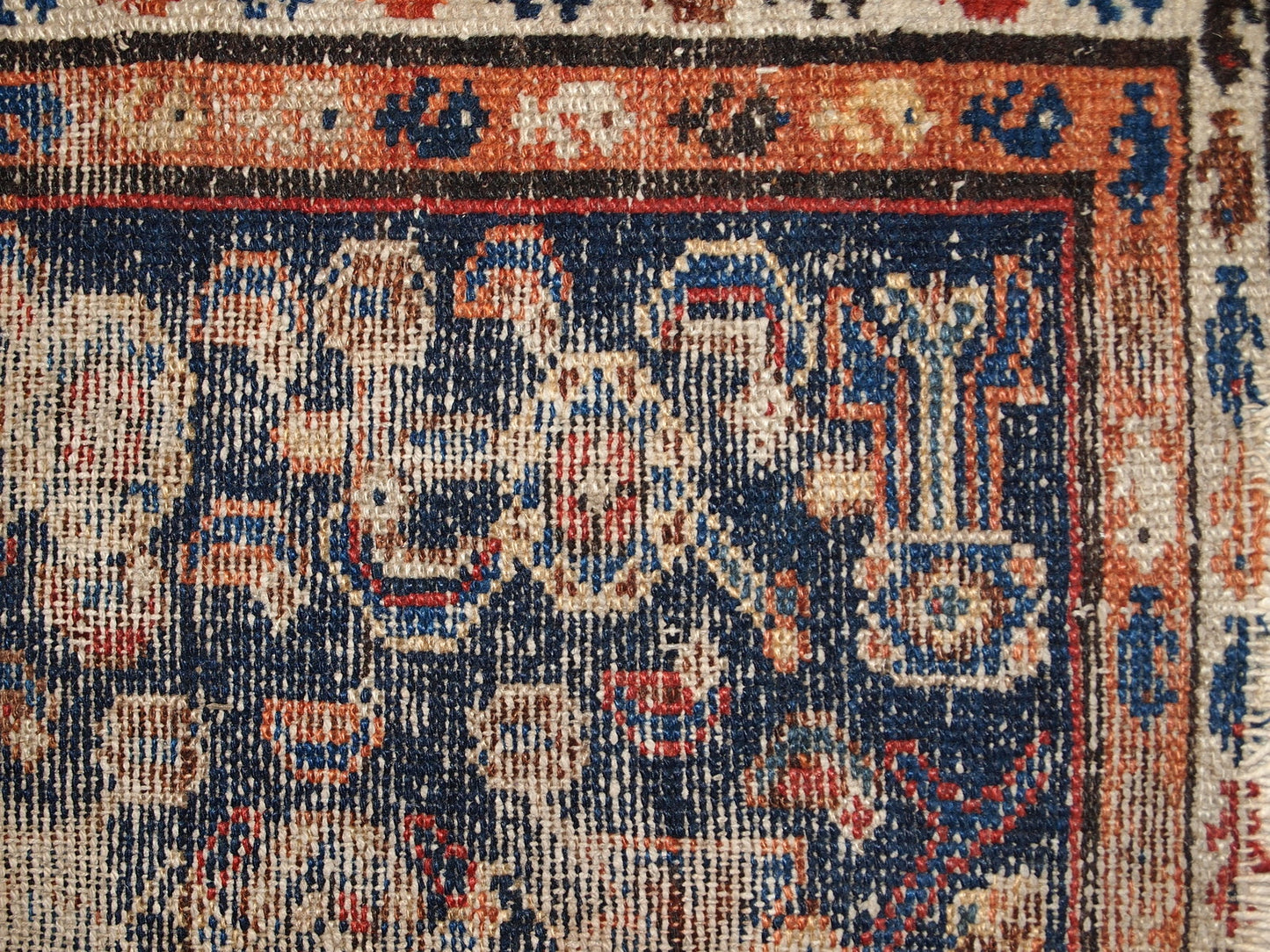 Handmade antique Middle Eastern rug in traditional design. The rug is from the beginning of 20th century in distressed condition.