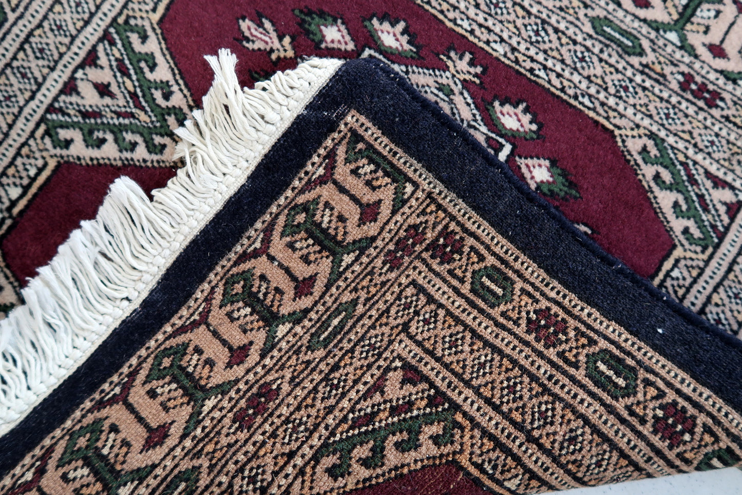 Handmade vintage Uzbek Bukhara mat in original good condition. The rug has been made in wool in the end of 20th century.