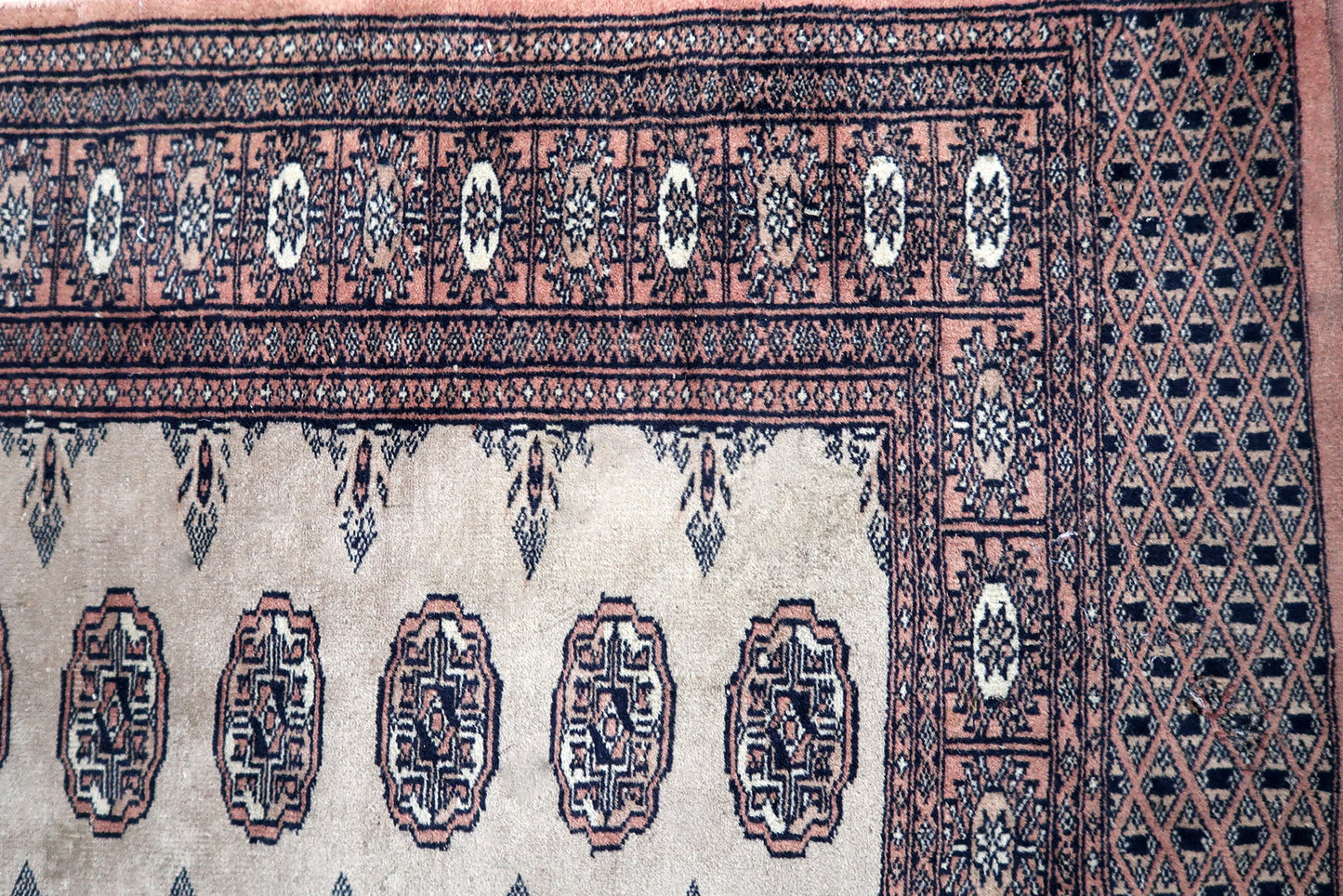 Handmade vintage Uzbek Bukhara distressed runner in traditional design. The rug is from the end of 20th century made in wool.