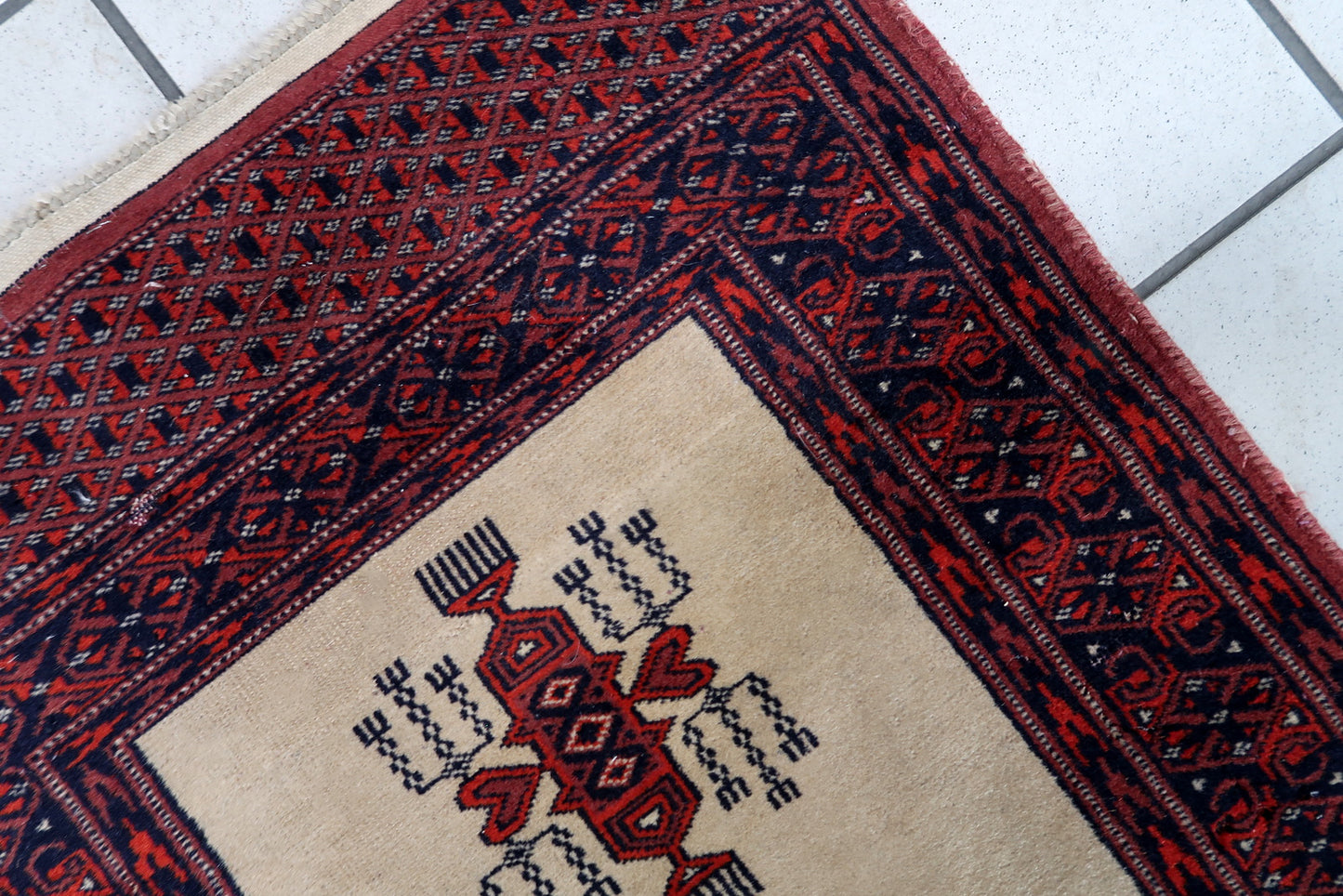 Handmade vintage Uzbek Bukhara runner in traditional design. The rug is from the end of 20th century made in wool.