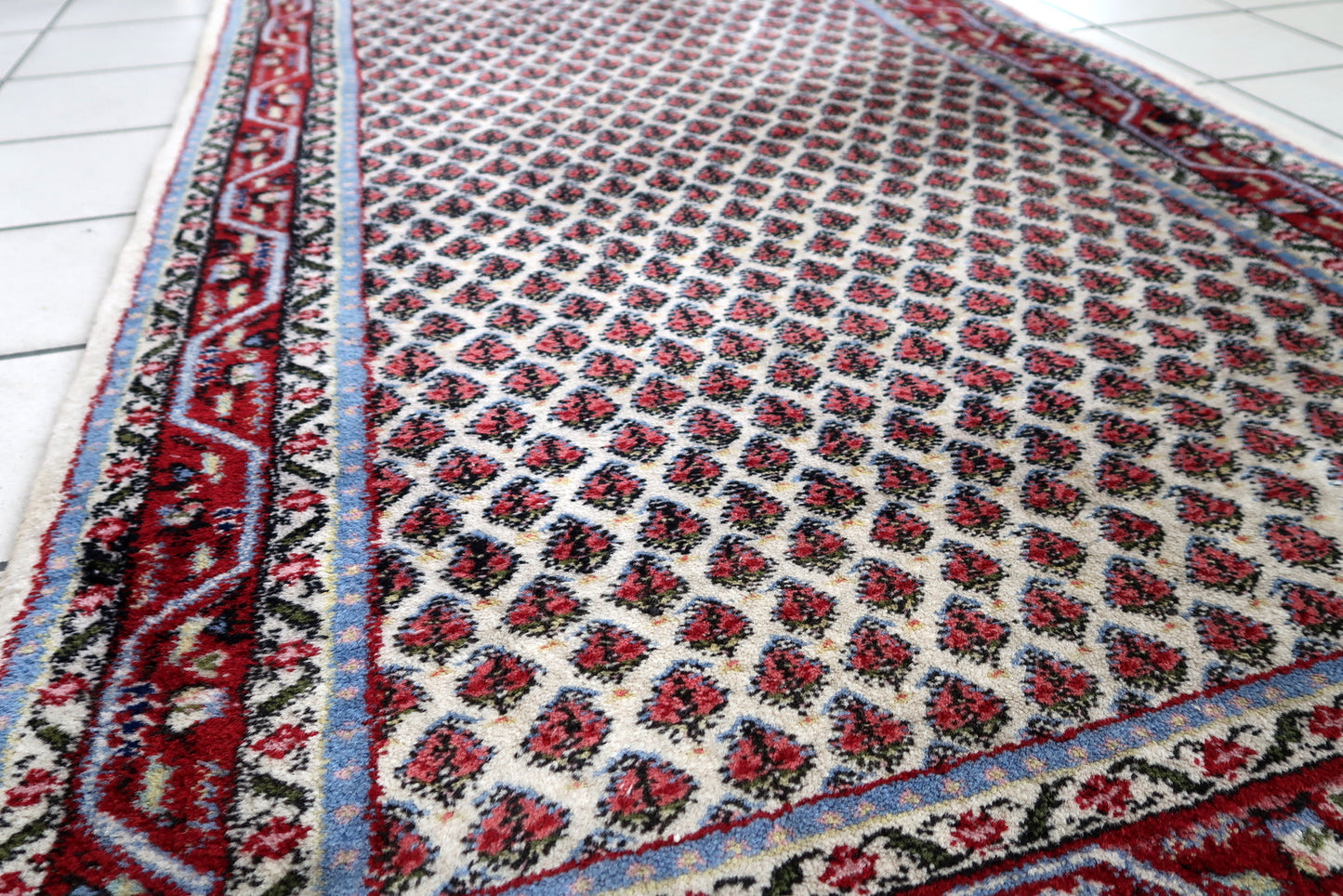 Handmade vintage Indian Seraband rug in original good condition. The rug has been made in wool in the end of 20th century.