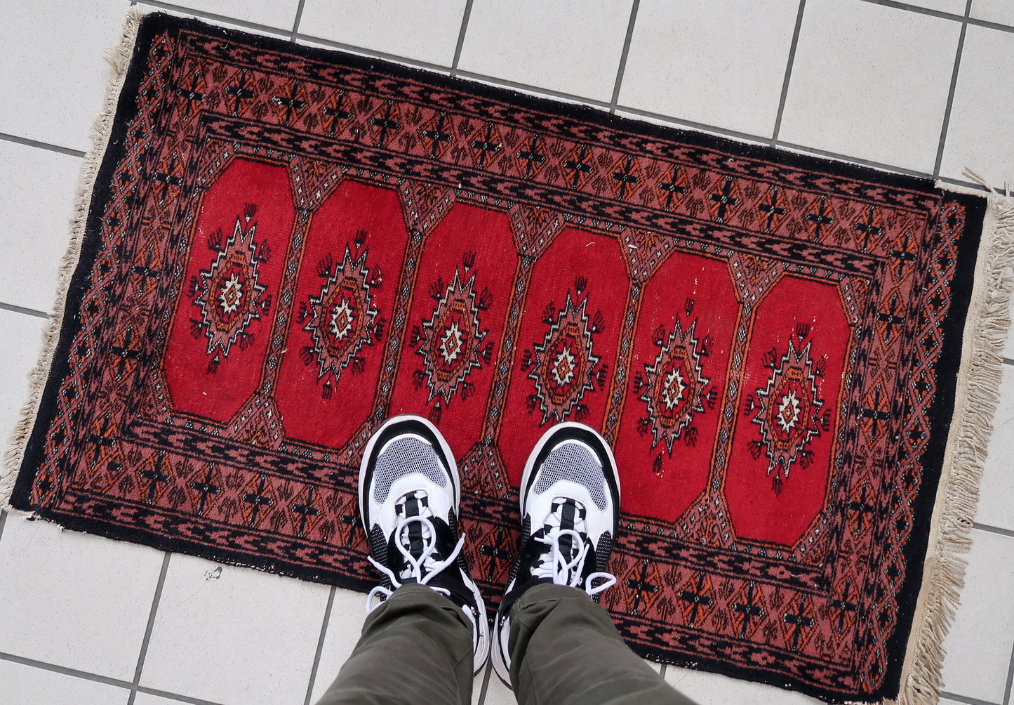 Handmade vintage Uzbek Bukhara rug in traditional design. The rug is from the end of 20th century made in wool.
