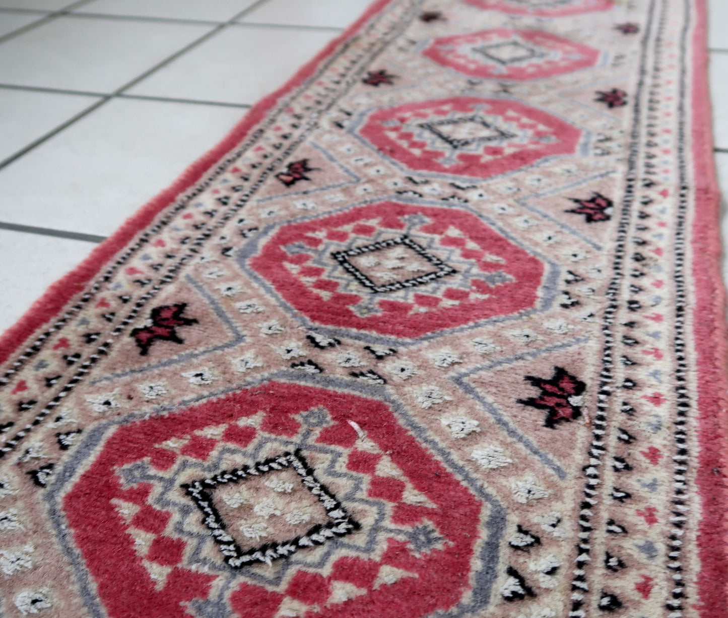 Vintage Uzbek Bukhara mat in light shades. The rug is from the end of 20th century made in wool with silk highlights. The rug is in original good condition.