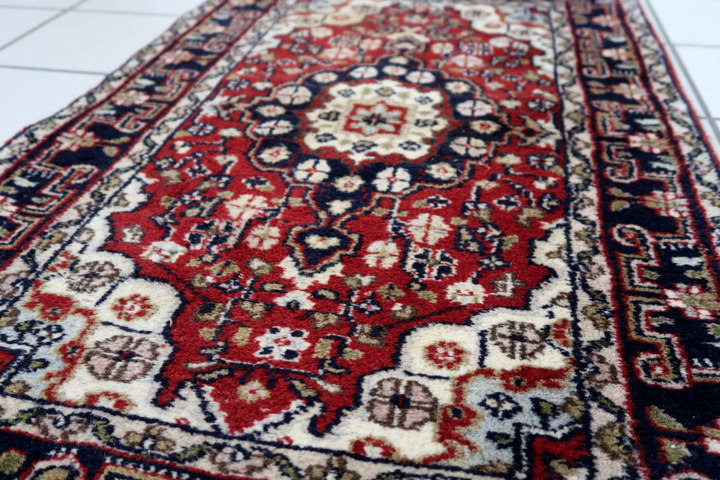 Handmade vintage Middle Eastern rug in traditional medallion design. The rug has been made in wool in the end of 20th century. It is in original good condition