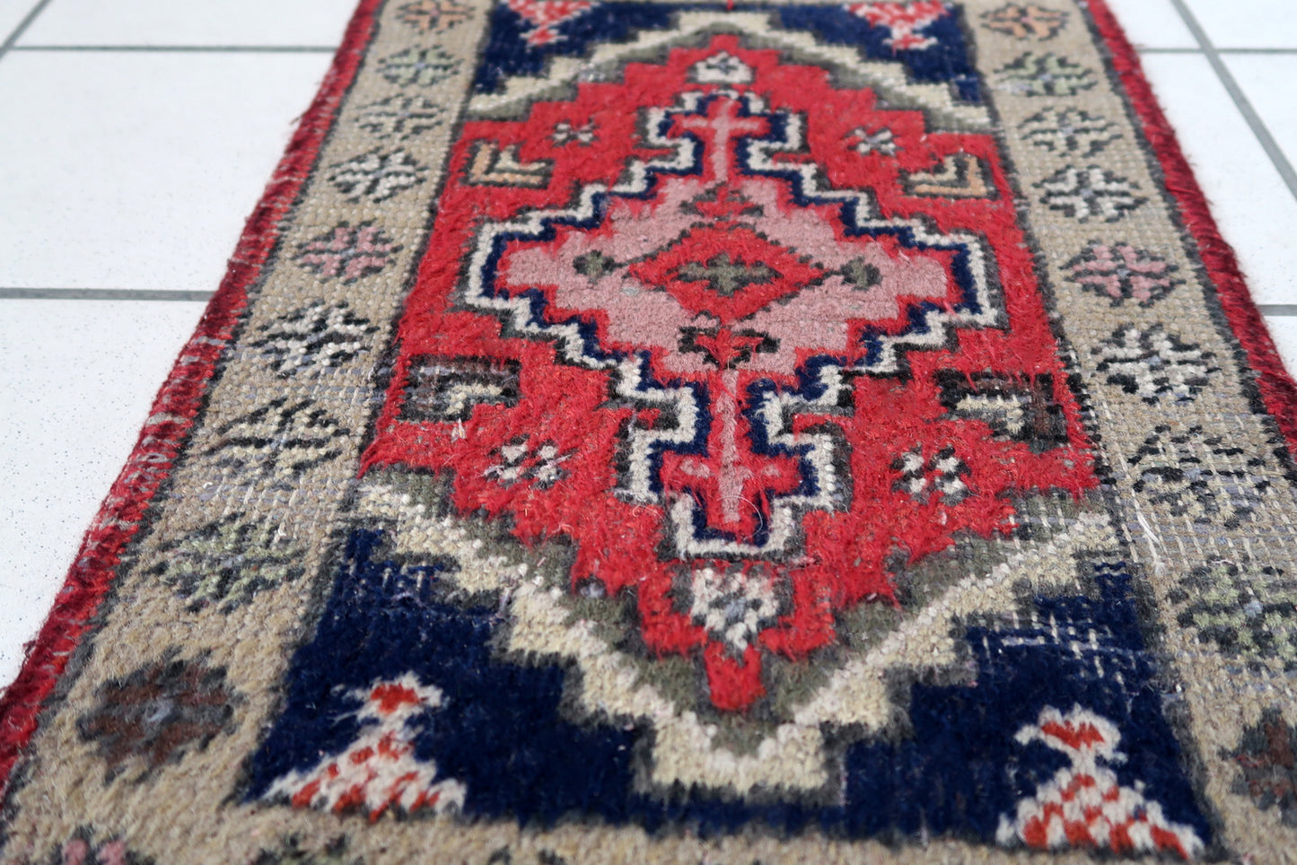 Handmade vintage Middle Eastern rug in traditional medallion design. The rug has been made in wool in the end of 20th century. It is in original condition, has some low pile.