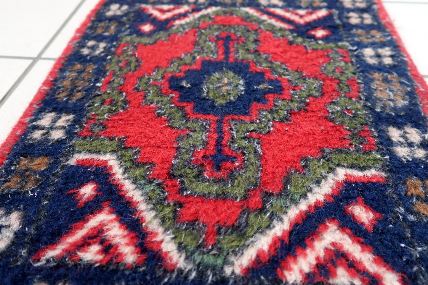 Handmade vintage Middle Eastern rug in traditional medallion design. The rug has been made in wool in the end of 20th century. It is in original good condition.