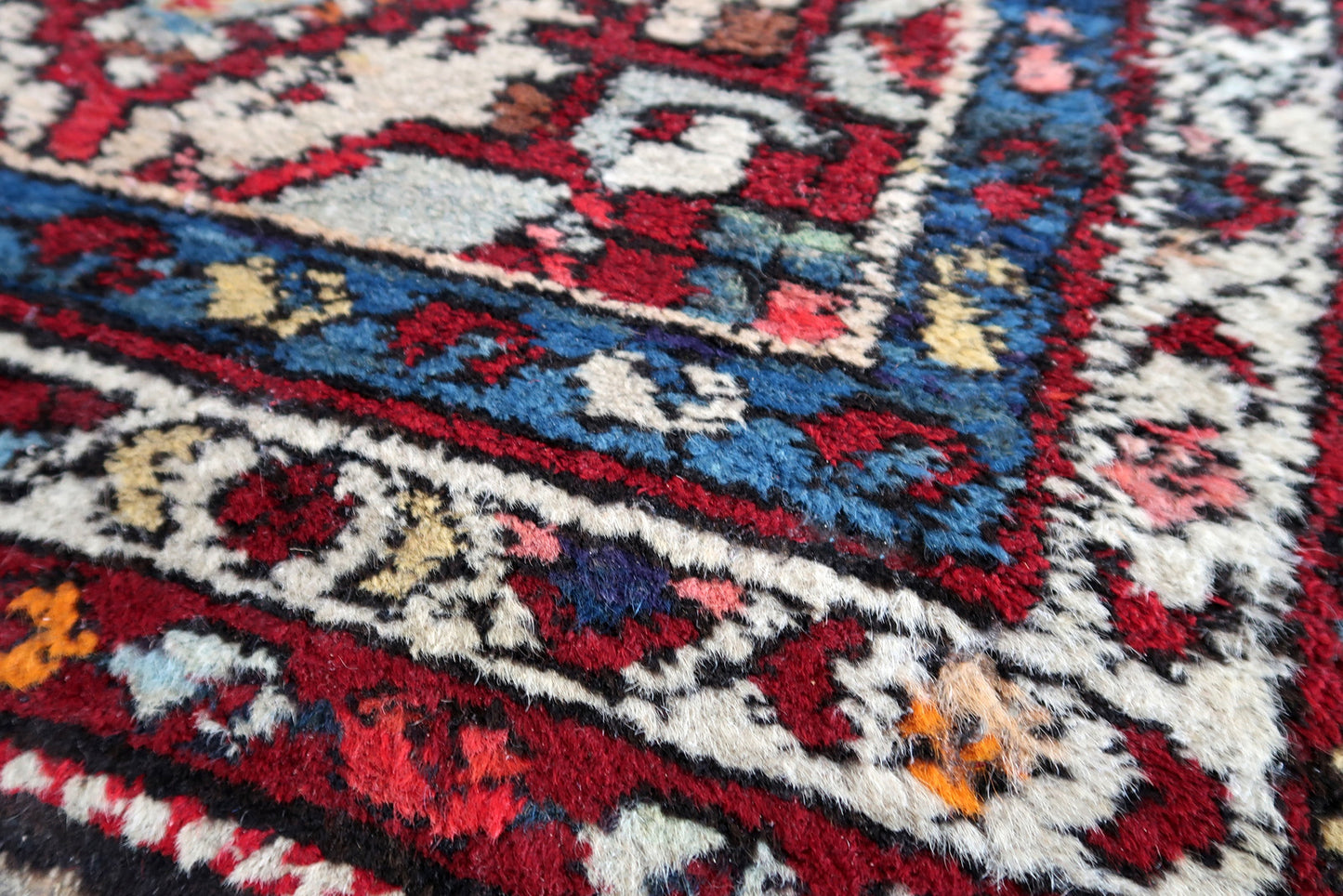 Handmade vintage Persian Malayer rug in red color. The rug has been made in wool in the middle of 20th century. It is in original condition, it has some signs of age.