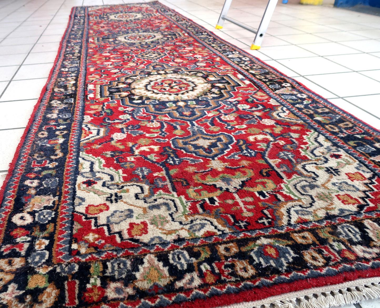 Handmade vintage Persian Malayer runner in red color. The rug has been made in wool in the middle of 20th century. It is in original condition, it has some signs of age.