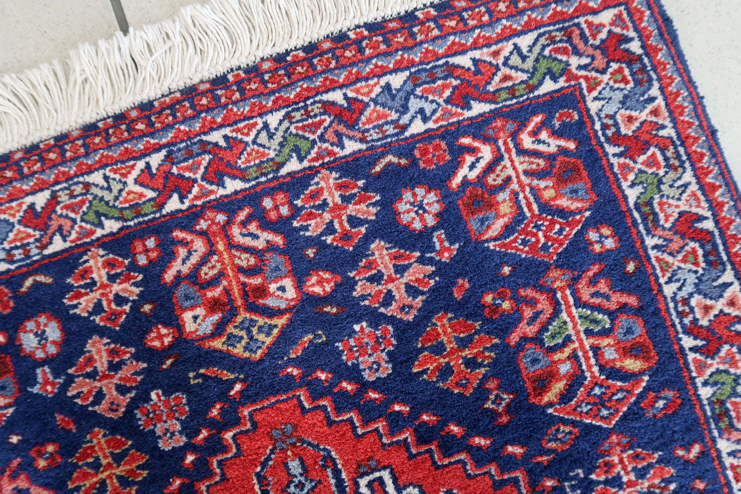 Handmade vintage Indian Tabriz narrow runner in all-over design. The rug is from the end of 20th century, it is in original good condition. The rug has been made in India but with Persian design.