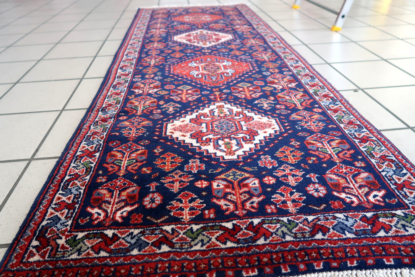 Handmade vintage Indian Tabriz narrow runner in all-over design. The rug is from the end of 20th century, it is in original good condition. The rug has been made in India but with Persian design.