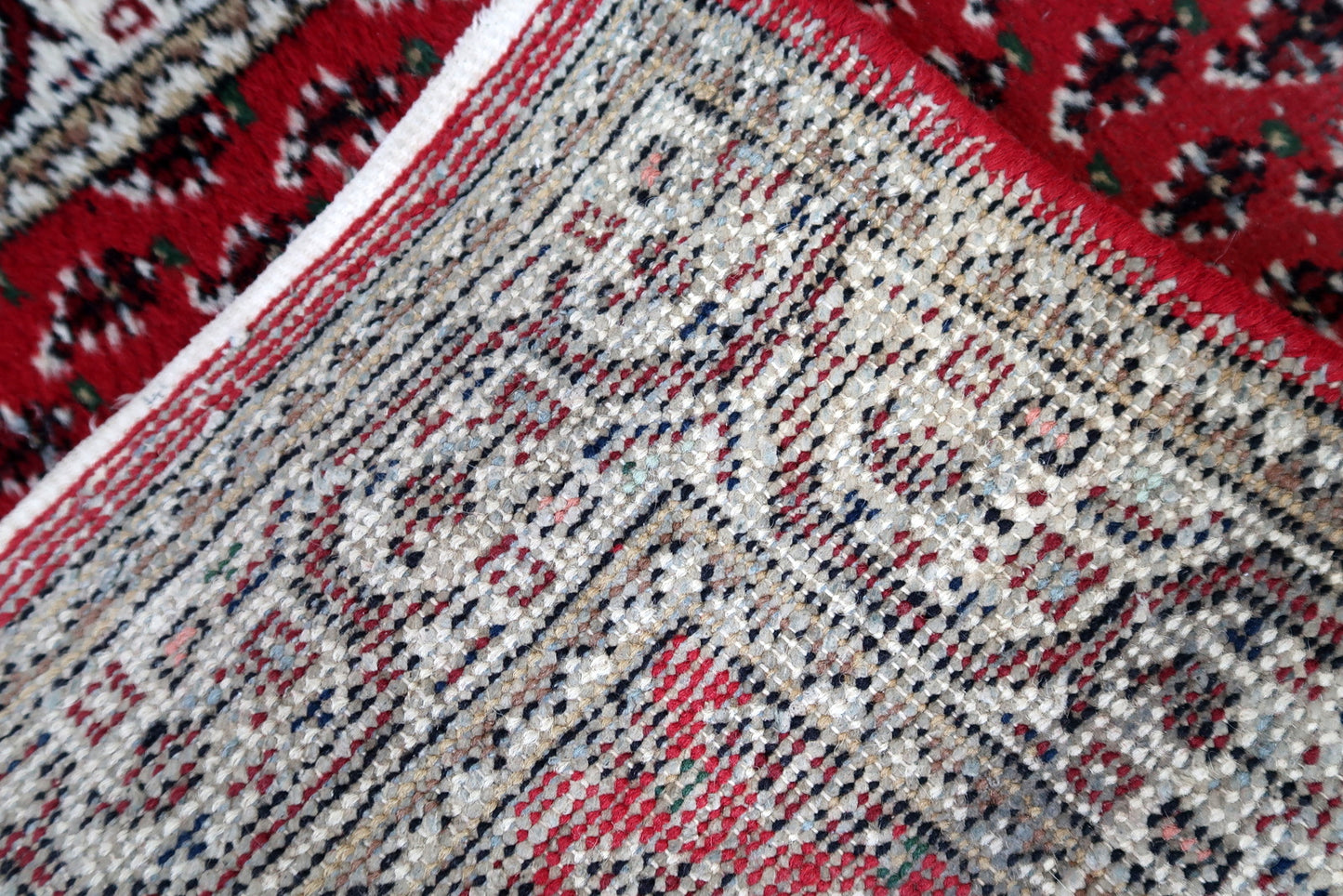 Handmade vintage Indian Seraband rug in red color and all-over design. The rug has been made in the end of 20th century. It is in original condition, has some low pile.