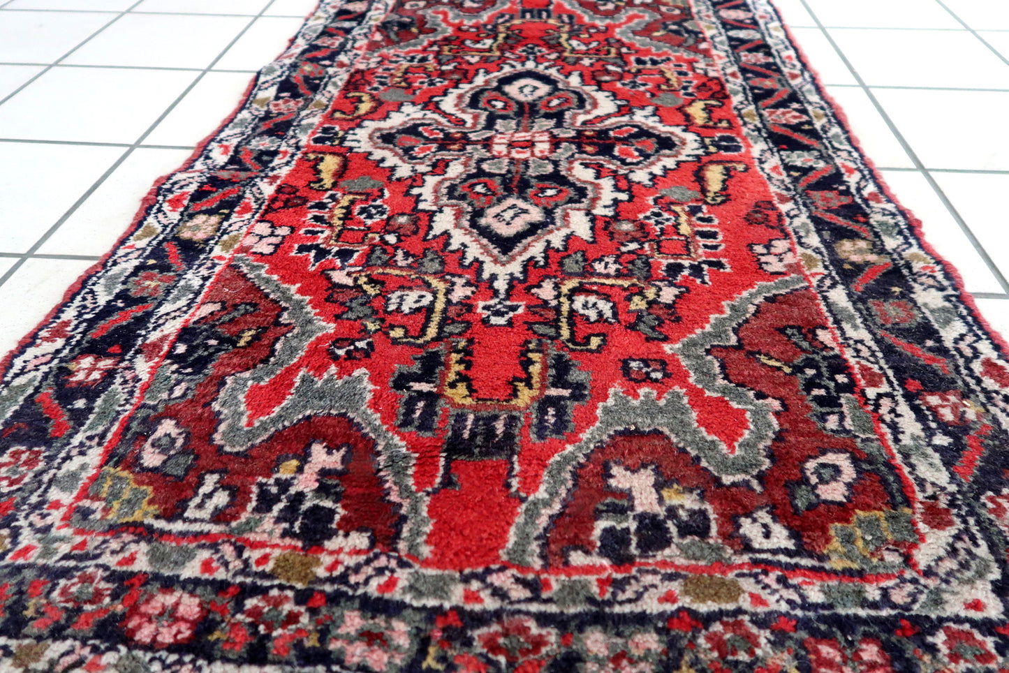 Handmade vintage Middle Eastern rug in traditional medallion design. The rug has been made in wool in the end of 20th century. It is in original good condition.