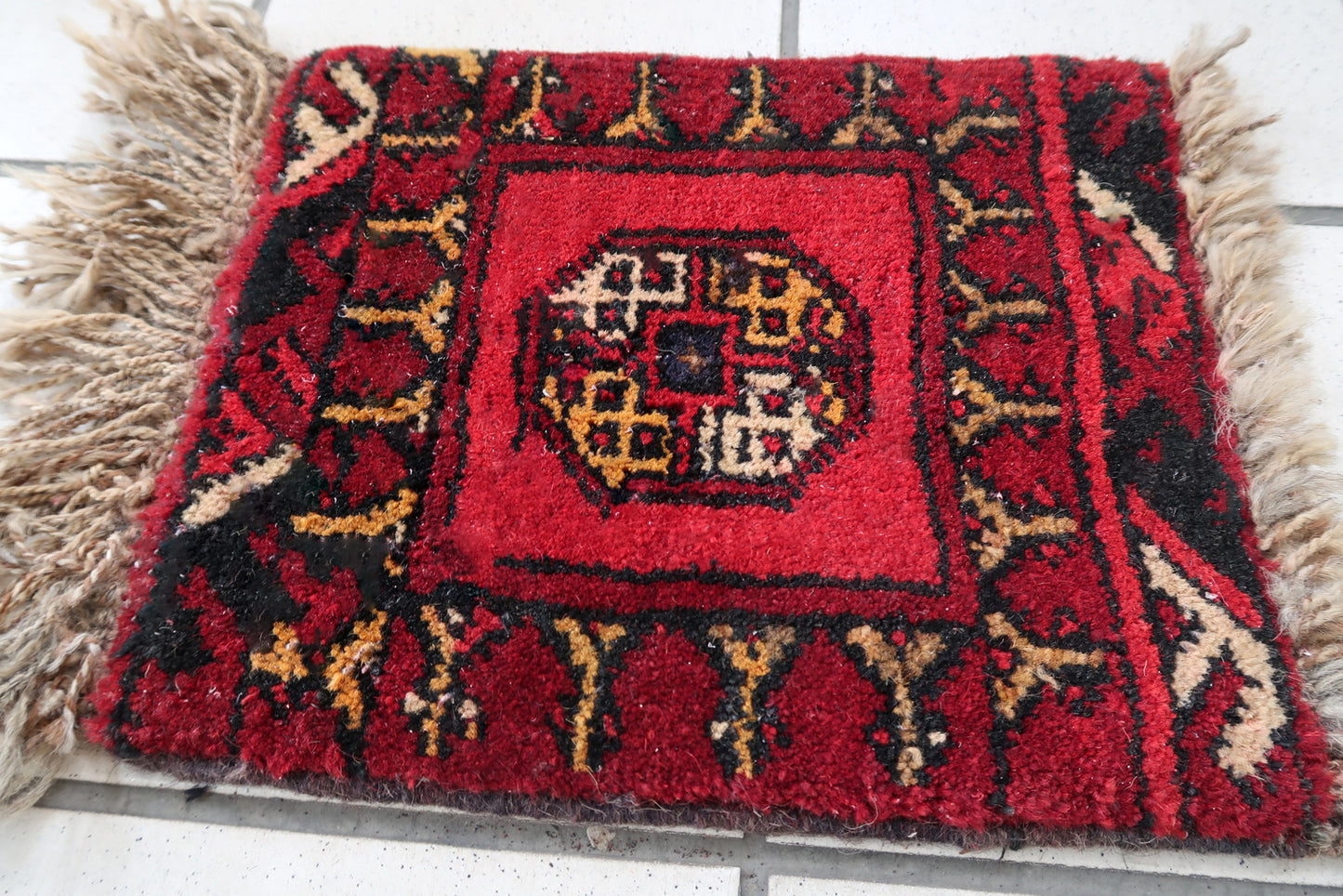 Handmade vintage Afghan Ersari mat in bright red shade. The rug is from the end of 20th century in original good condition. It can be used as a doll house rug.