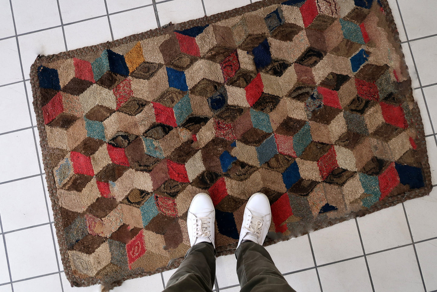 Handmade antique American Hooked rug in geometric design. The rug is from the end of 19th century. The rug has some old restorations.