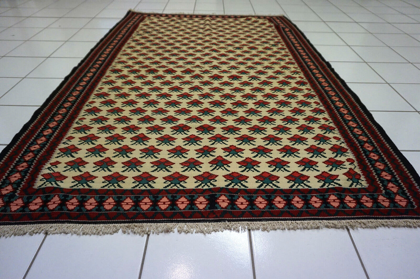 Close-up of the intricate handwoven pattern of the Ardabil Kilim rug