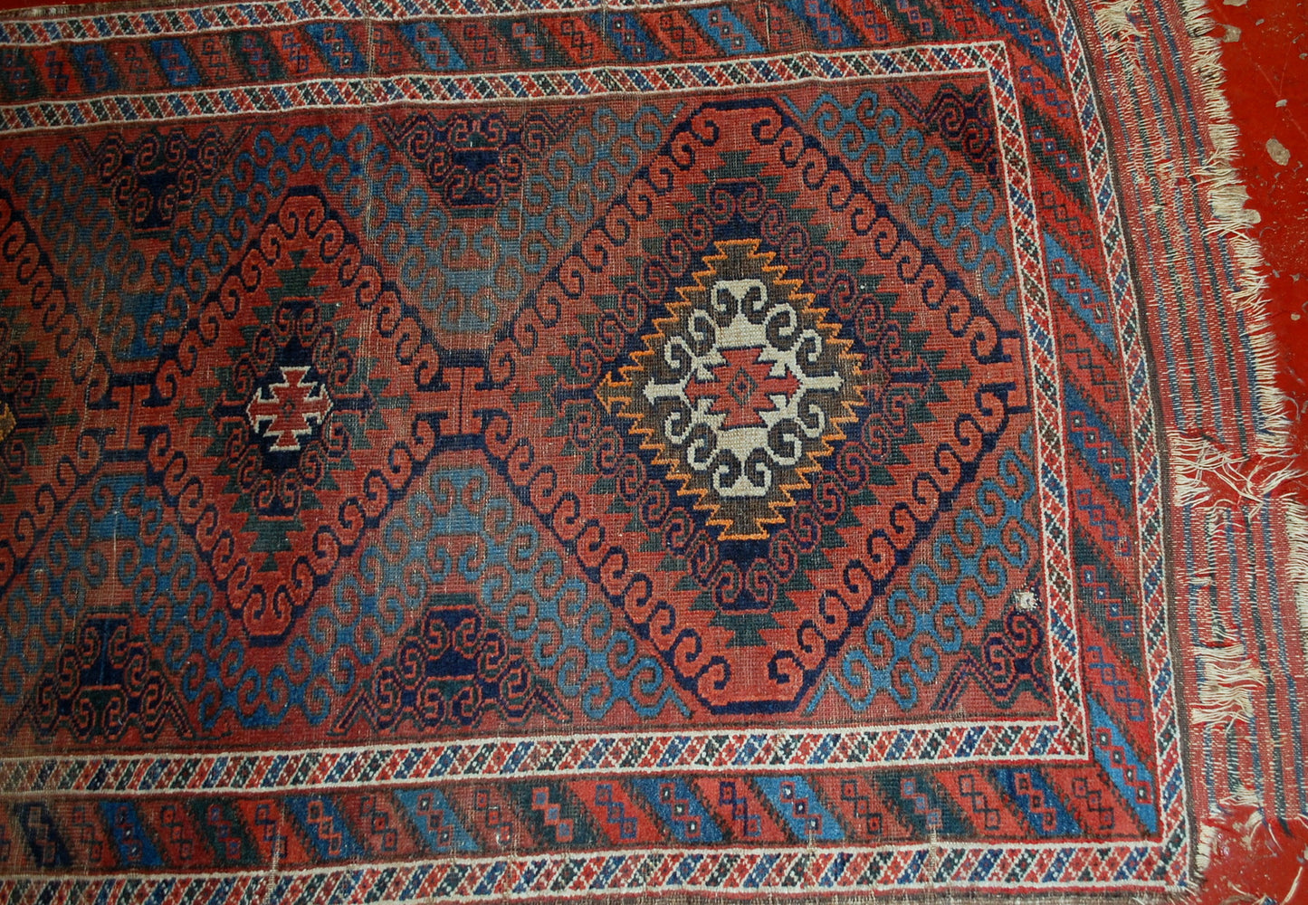 Hand made antique collectible Afghan Baluch rug in original condition, it has some low pile. The rug is from the beginning of 20th century.