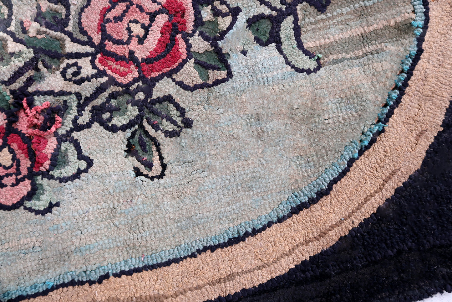 Handmade antique American Hooked rug in floral design. The rug is from the beginning of 20th century. It has some old restorations and discolorations.