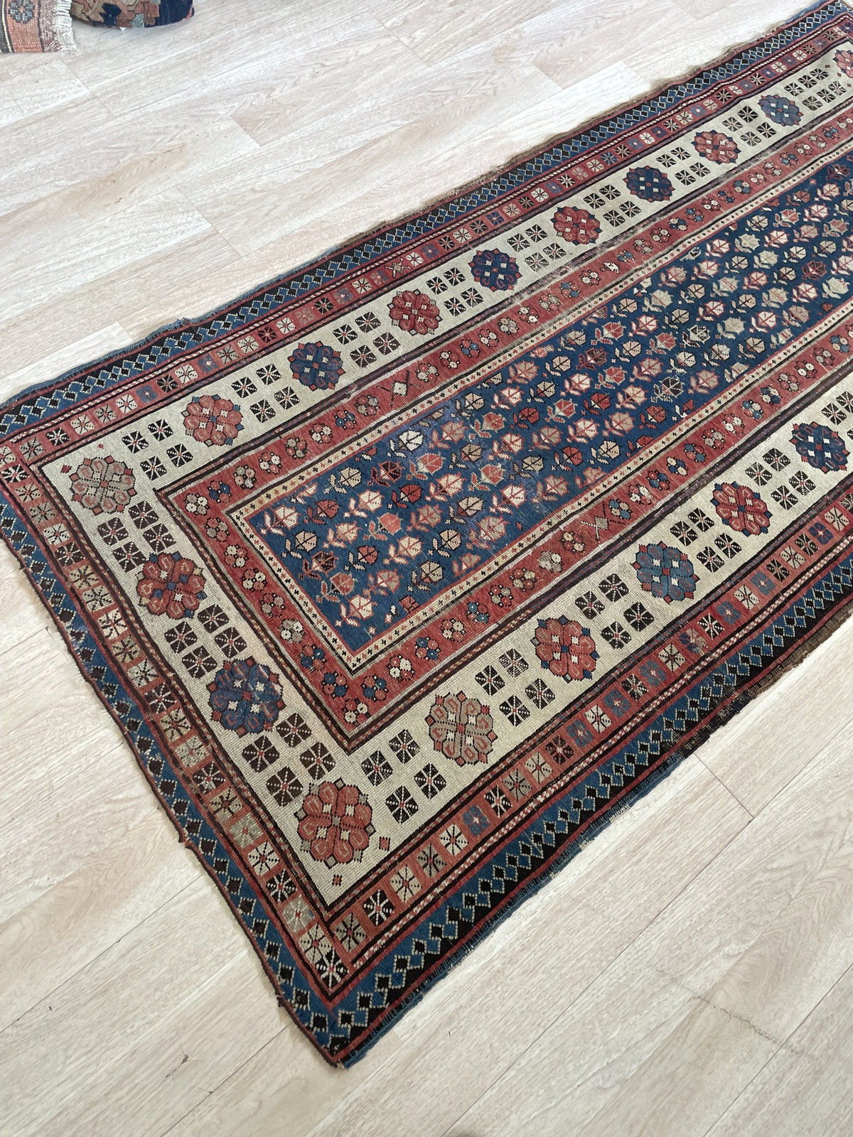 Antique Caucasian runner measuring 3'7" × 7'4", hand-knotted in the Talish region of the southern Caucasus circa 1880s, with a deep indigo field of botanical lattice motifs and a wide ivory border.

