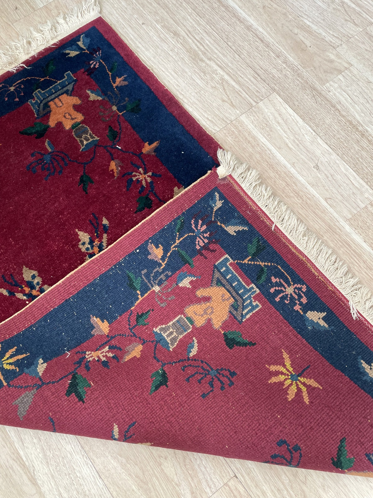 Antique hand-knotted wool rug from the Chinese Art Deco period, circa 1920s, in fair to good condition with some low pile areas in the field center (disclosed), but vivid colors and sound structure.

