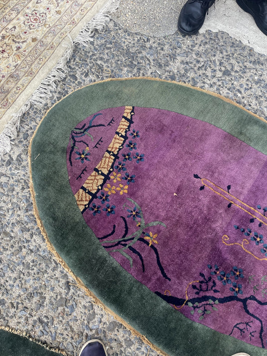 Antique small oval Chinese Art Deco hand-knotted wool rug measuring 3.08 by 4.83 feet