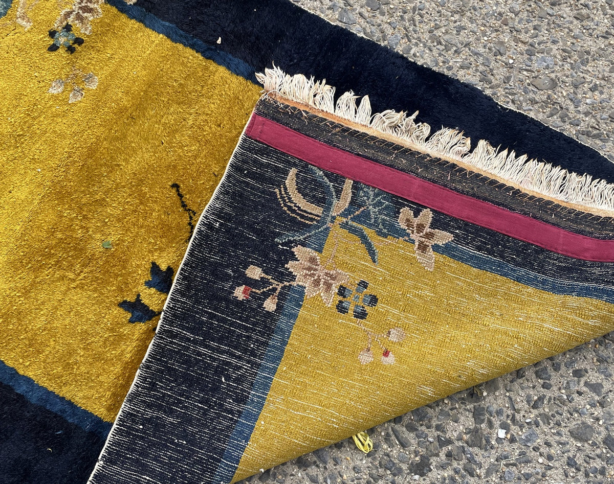 Reverse weave, light fringe and fabric strip along an end of Chinese rug 1B1007