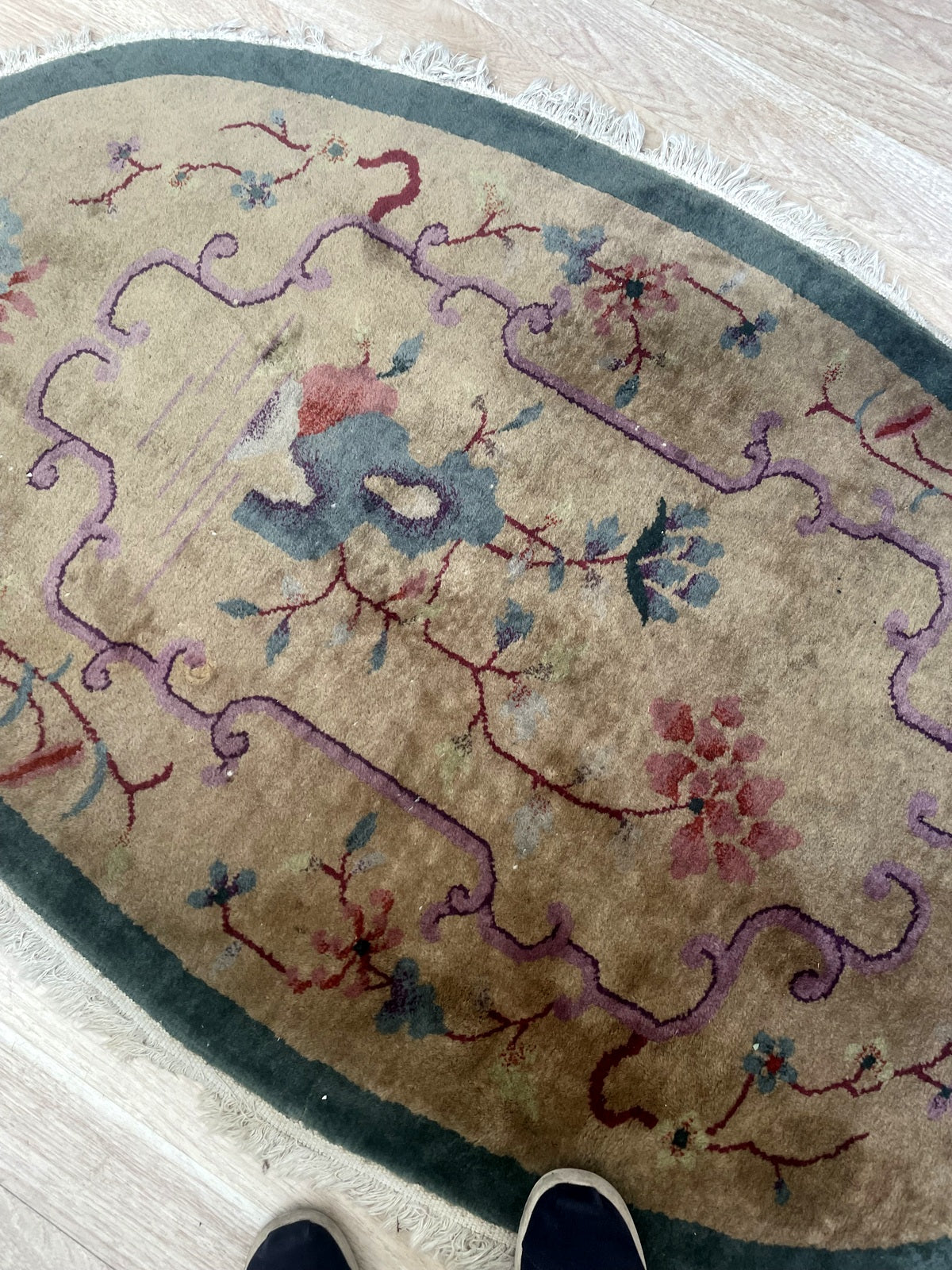 Rounded end with blue flowers, teal border and worn light fringe