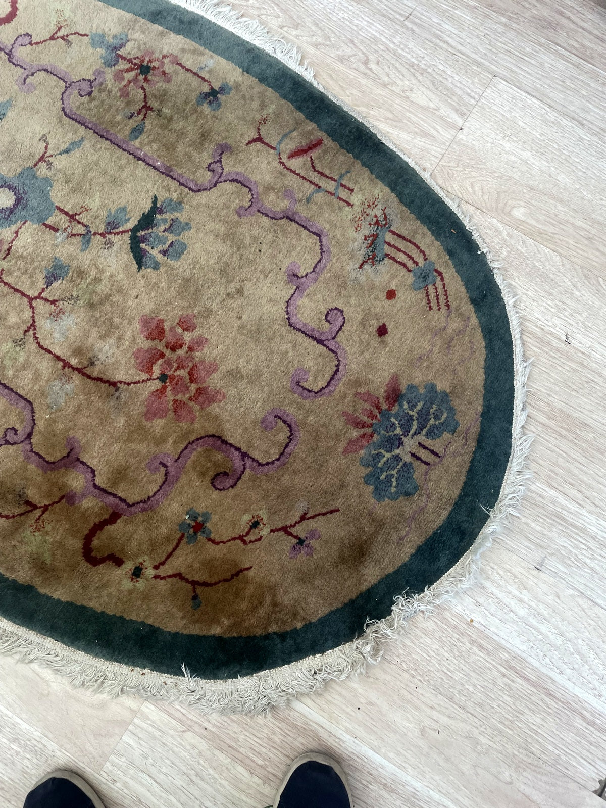 Floral end detail showing lilac scrolls, pink blossoms and uneven fringe
