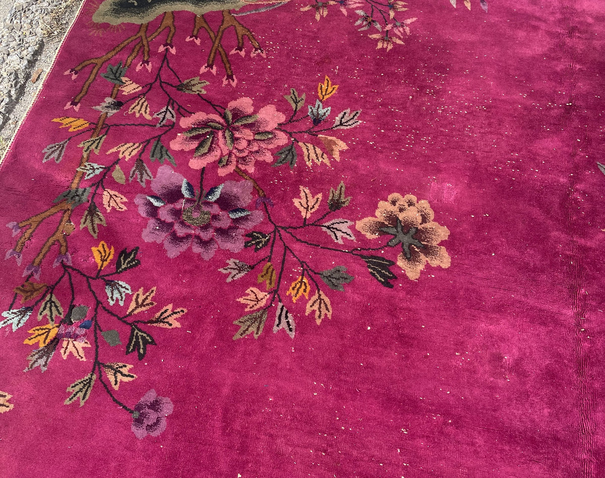 Multicoloured leaves and oversized flowers extending across the magenta field