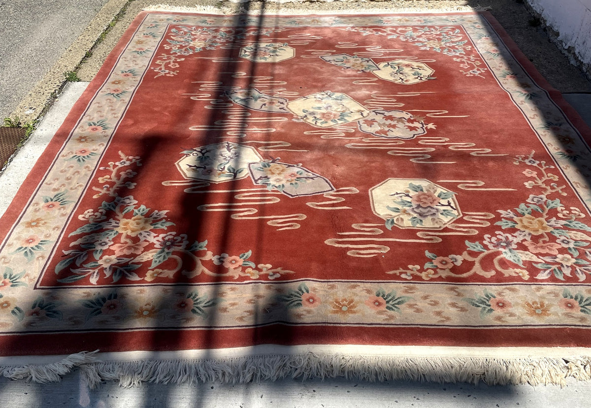 Overall rug view showing scattered floral panels, corner bouquets and ivory floral border