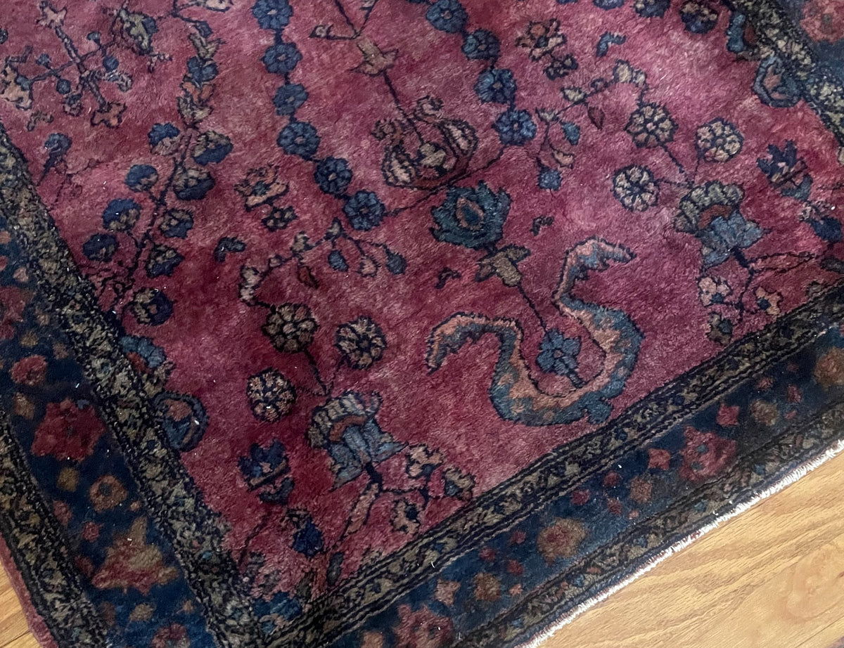Curling blue and gold motif near one end of the rug