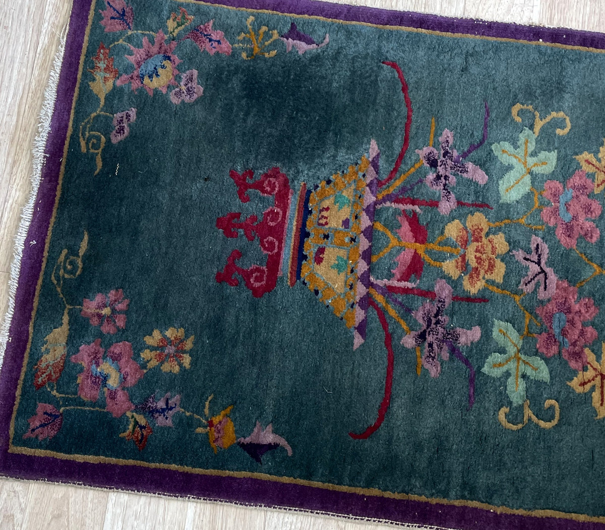 Lower floral basket and corner sprays with narrow purple border