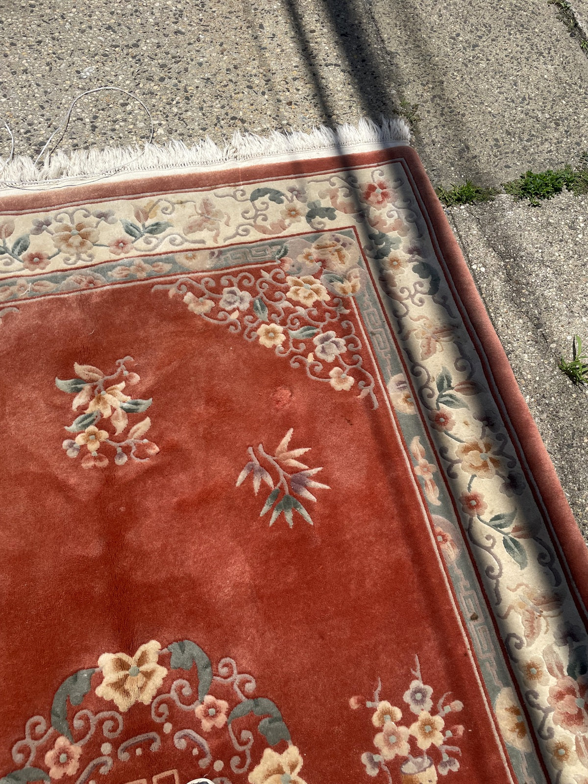 Upper-right corner showing ivory floral border and worn fringe