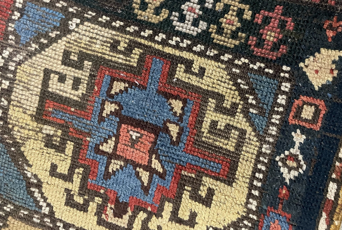 Pale yellow medallion containing blue and red hooked forms