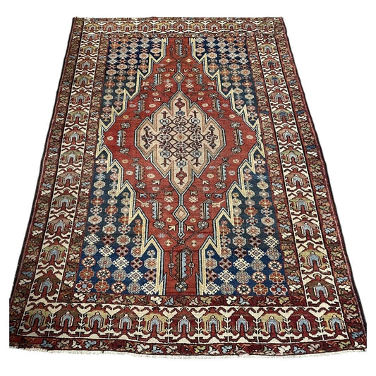 Antique wool rug 1B1018 with red field, pale medallion and deep blue side panels