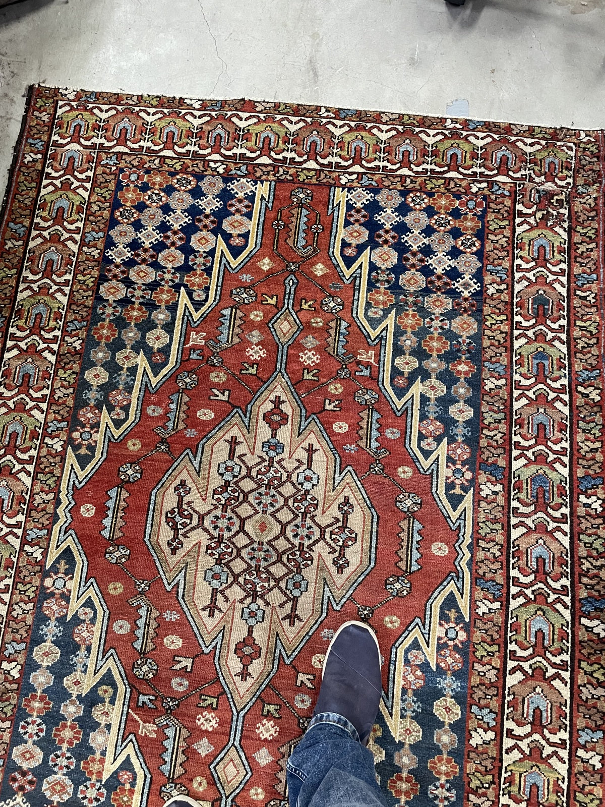 Detail showing low pile and scattered wear around the medallion