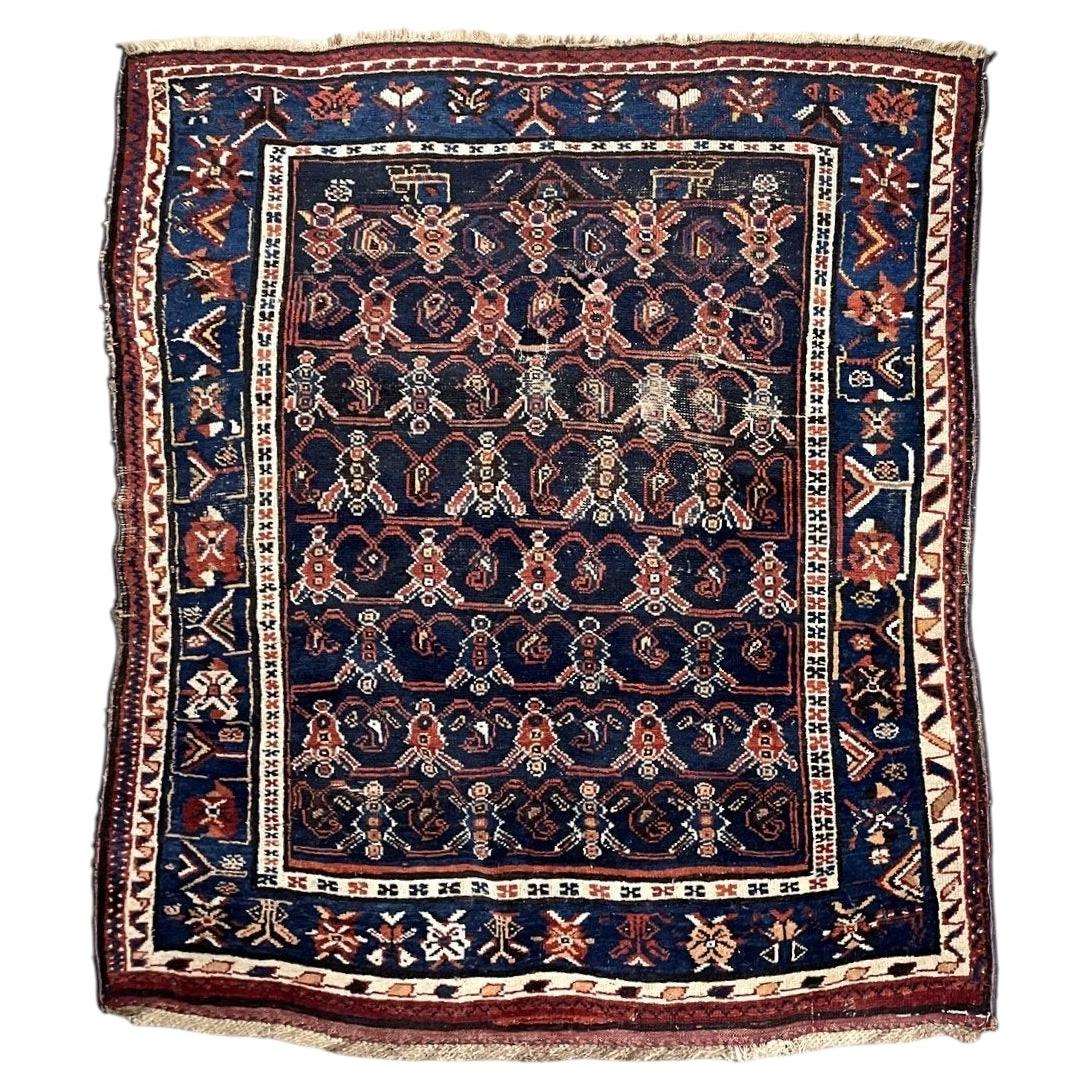 Antique navy wool rug with red floral lattice and a blue geometric border