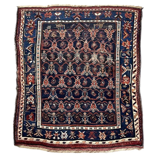Antique navy wool rug with red floral lattice and a blue geometric border