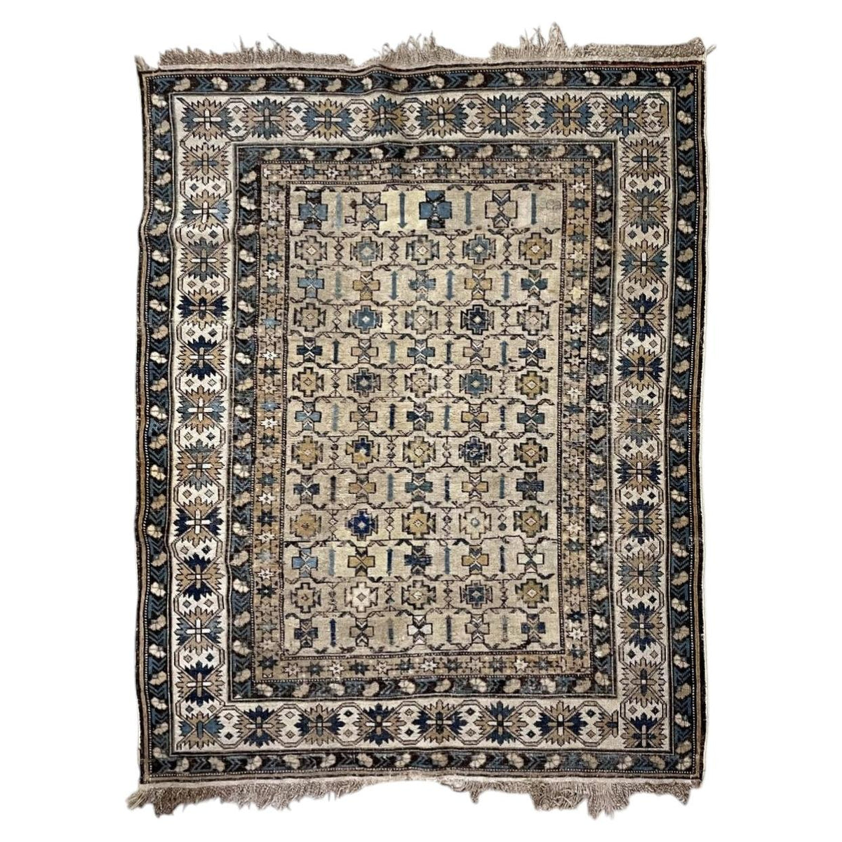 Antique ivory Shirvan wool rug with geometric rosettes and a starburst border