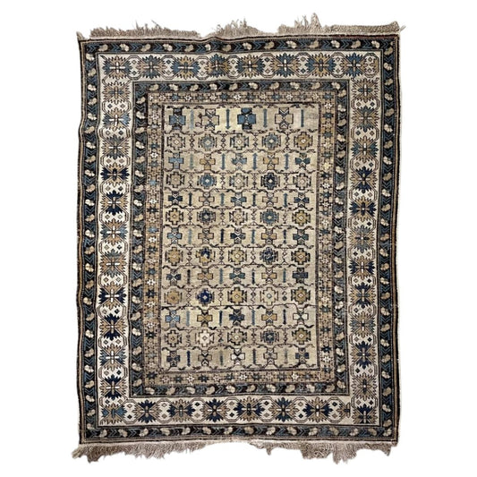 Antique ivory Shirvan wool rug with geometric rosettes and a starburst border