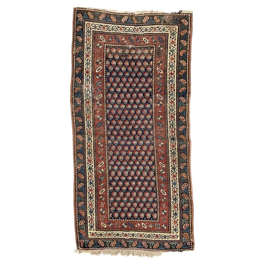 Antique Caucasian Gendje wool rug with repeating boteh on a navy field