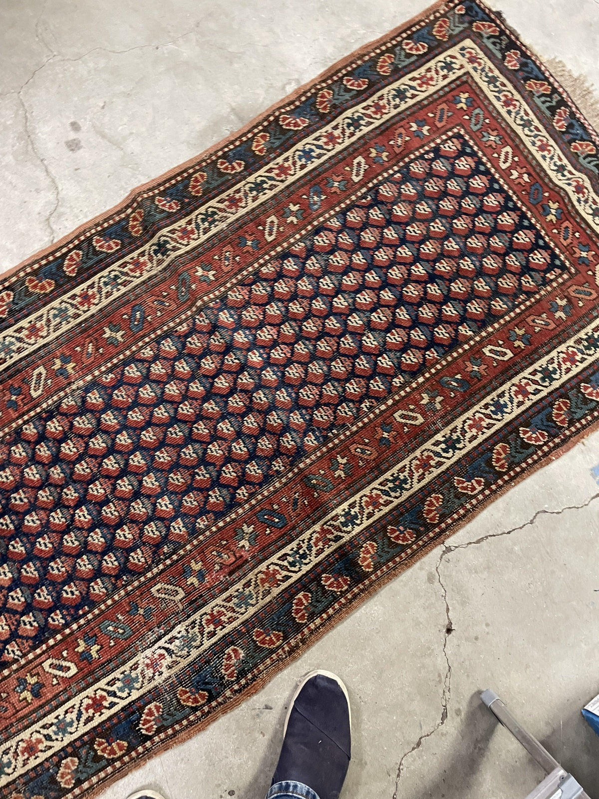Folded corner revealing the patterned reverse of the hand-knotted rug