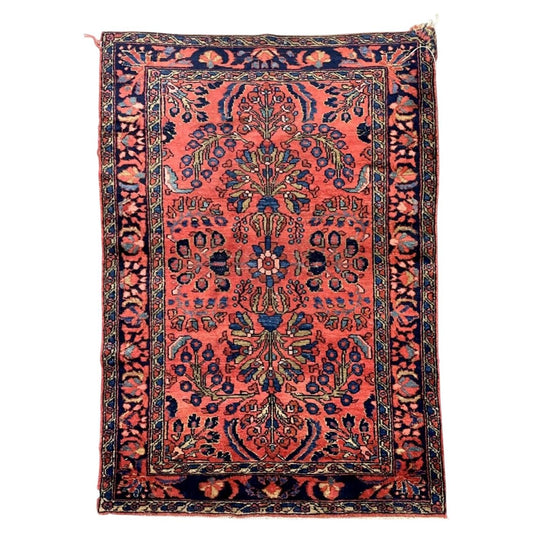 Antique coral-red wool rug with symmetrical bouquets and a navy floral border